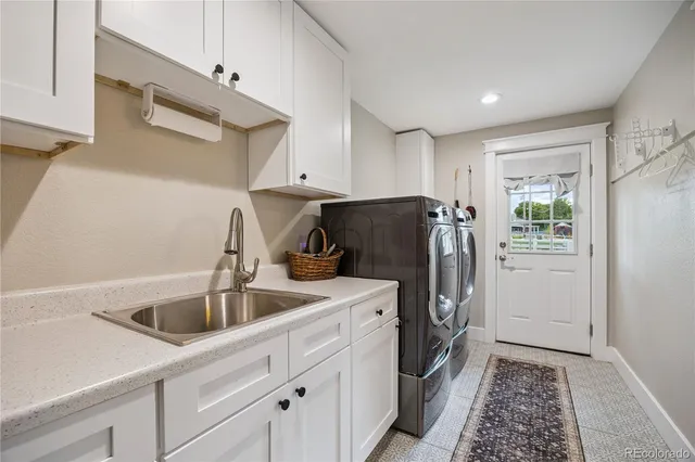 a kitchen with a sink appliances and cabinets