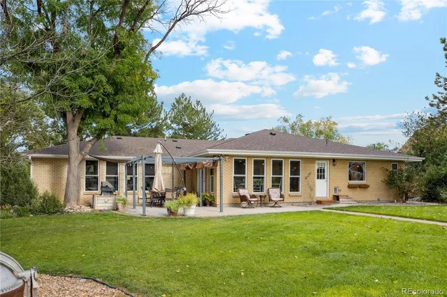 a front view of a house with a yard table and chairs