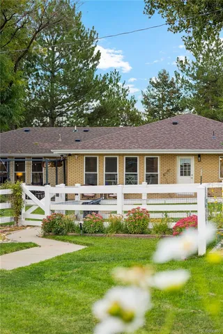 a front view of a house with swimming pool having outdoor seating