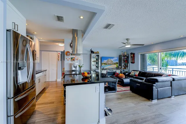 a living room with fireplace furniture and a large window