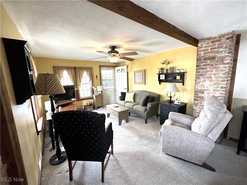 Living room offers carpet with wood flooring underneath.