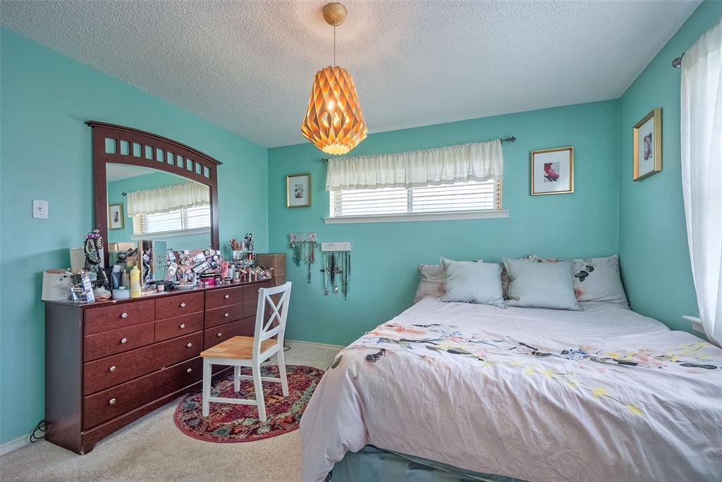 5739 Banting Way Dallas, TX 75227 - Photo 9 of 15 a bedroom with a bed and a table