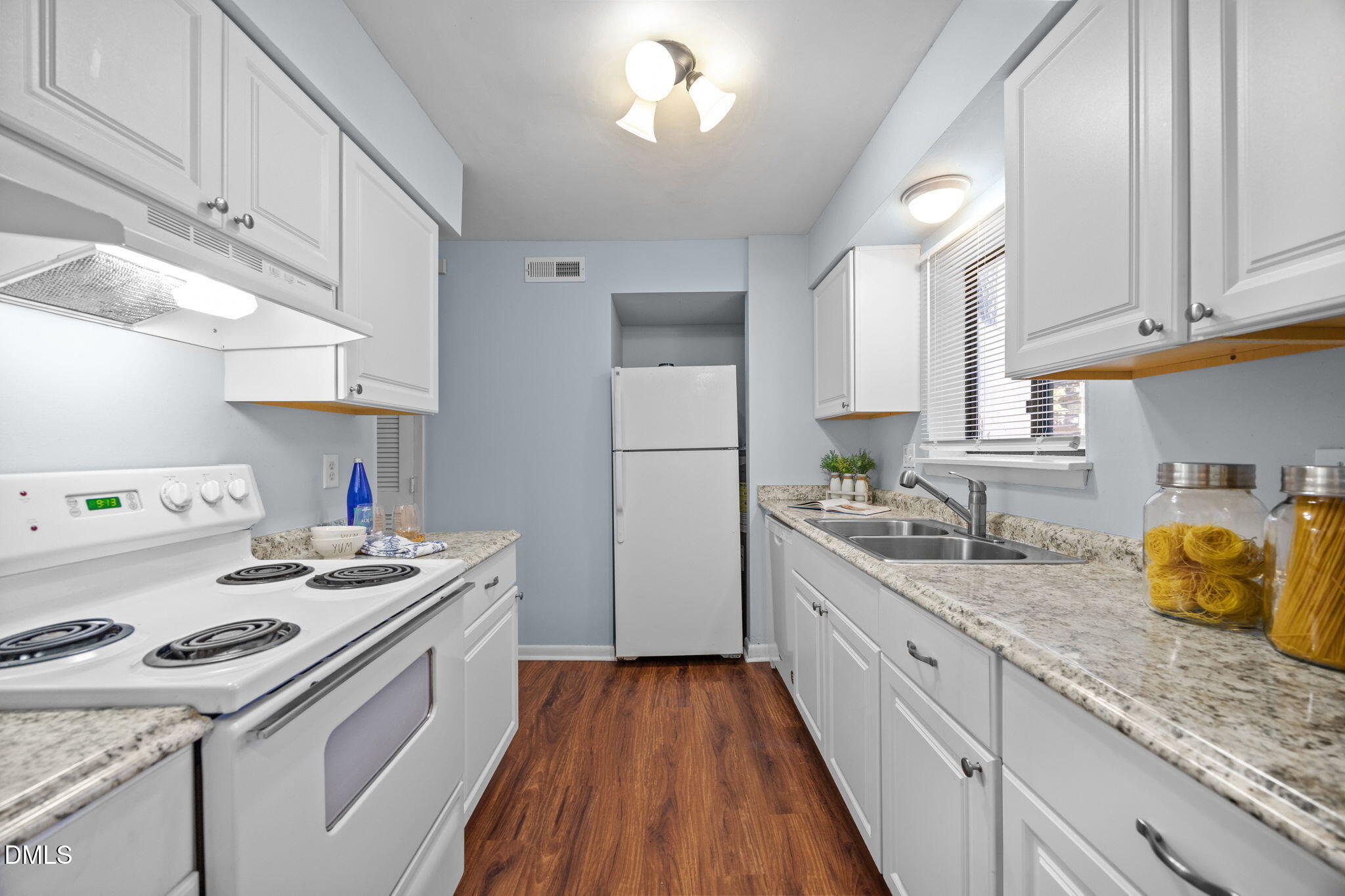 514 Pine Ridge Place Raleigh, NC 27609 - Photo 19 of 38 a kitchen with a sink a stove and cabinets