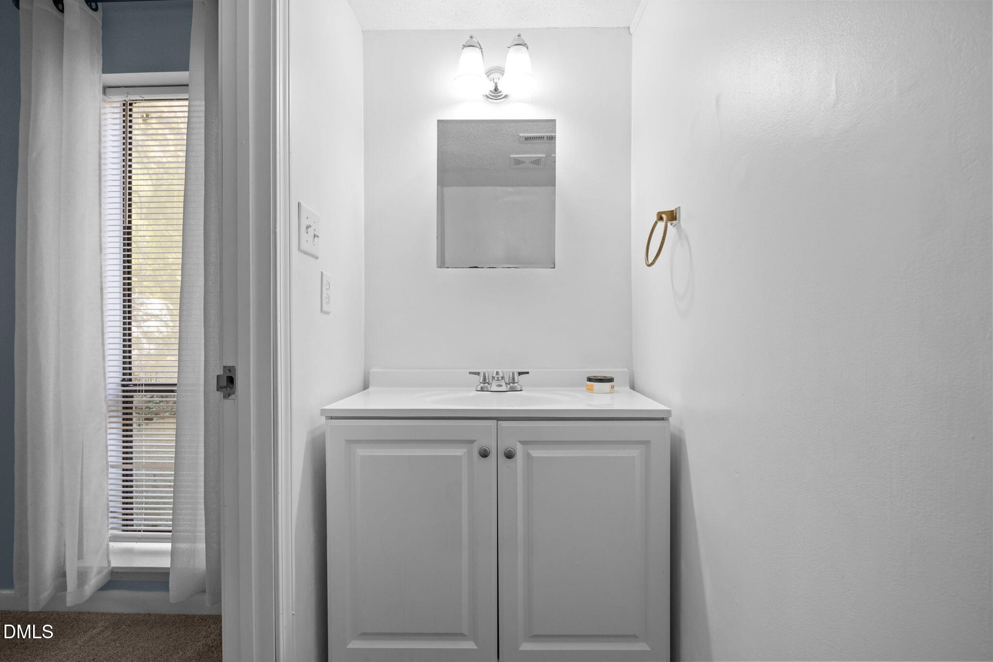 514 Pine Ridge Place Raleigh, NC 27609 - Photo 33 of 38 a bathroom with a sink and a mirror