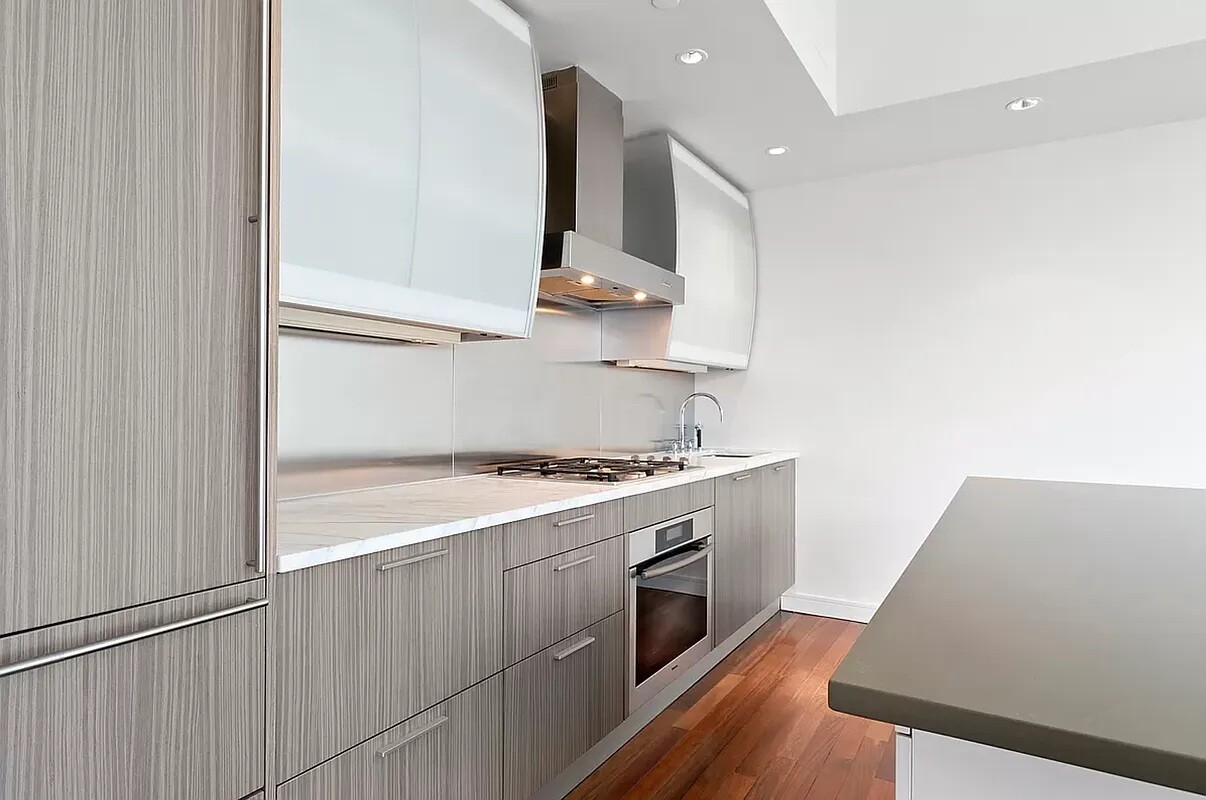 1 Irving Place, Unit 7B Manhattan, NY 10003 - Photo 2 of 8 a kitchen with a stove and a refrigerator