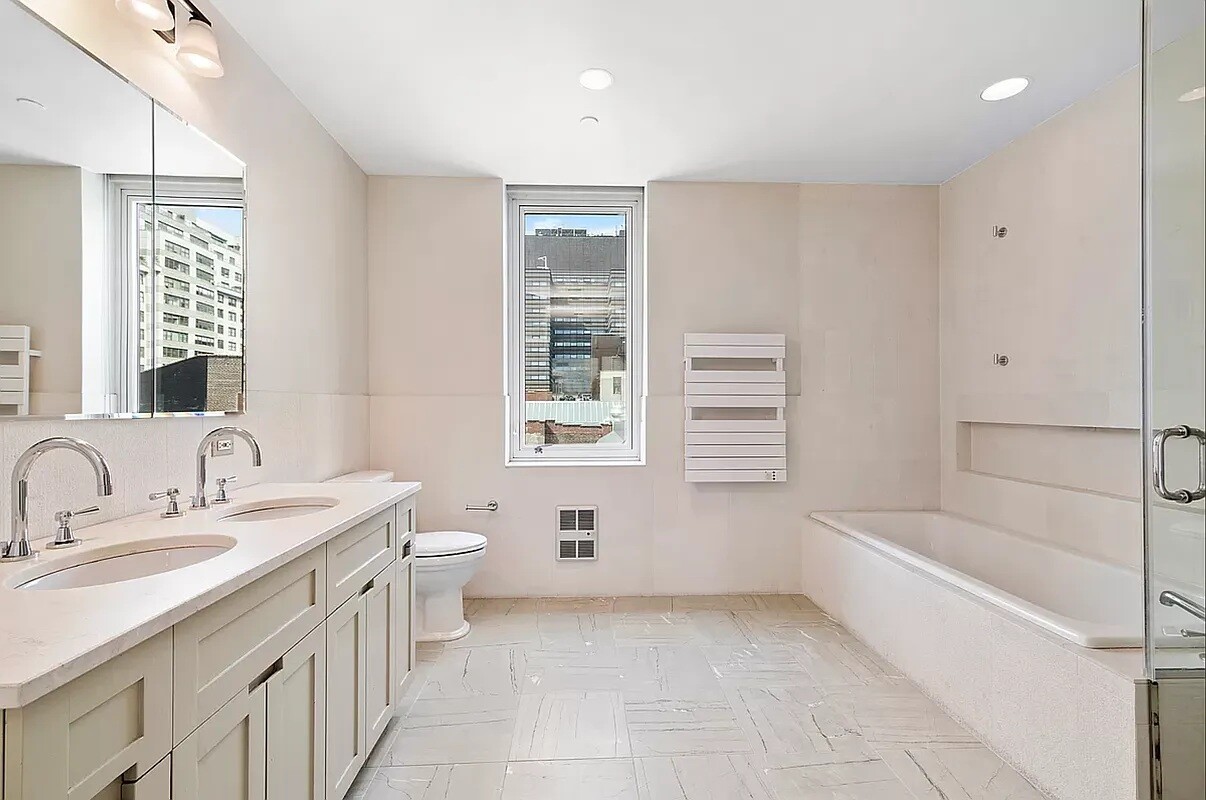 1 Irving Place, Unit 7B Manhattan, NY 10003 - Photo 5 of 8 a bathroom with a granite countertop sink a toilet and bathtub