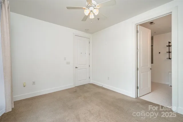 a view of room with window and ceiling fan
