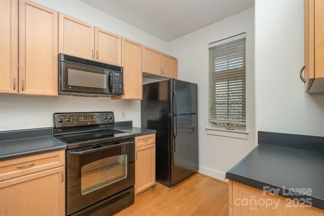 a kitchen with a refrigerator stove and microwave