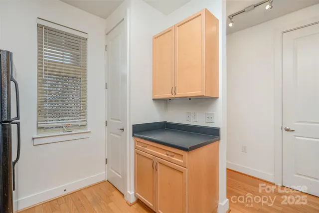 a utility room with wooden floor washer and dryer