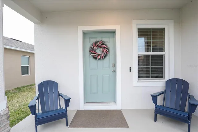 a view of hallway with furniture and a window