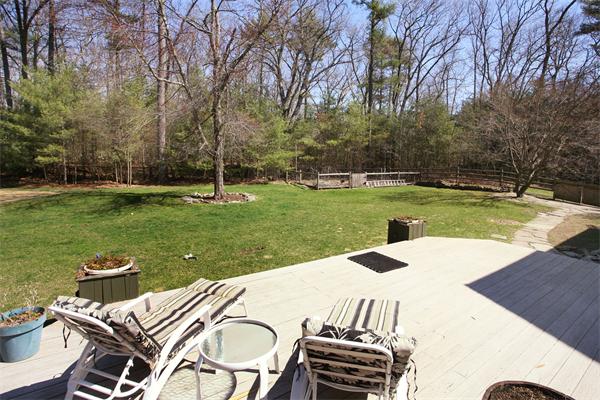 50 Depot Road Boxford, MA 01921 - Photo 20 of 23 a view of a backyard with table and chairs with a fire pit and a large tree