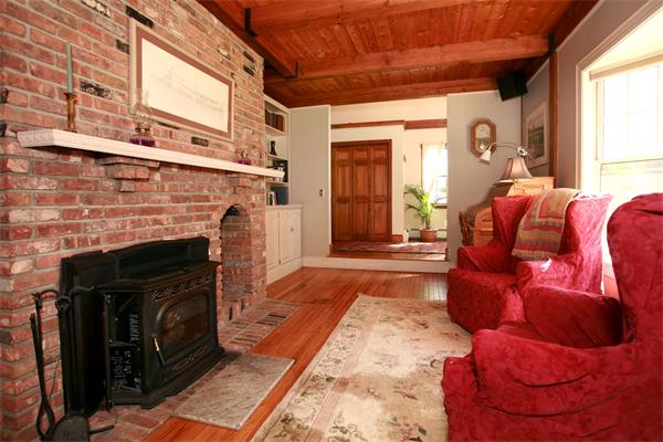 50 Depot Road Boxford, MA 01921 - Photo 10 of 23 a living room with a couch a fireplace and a large window