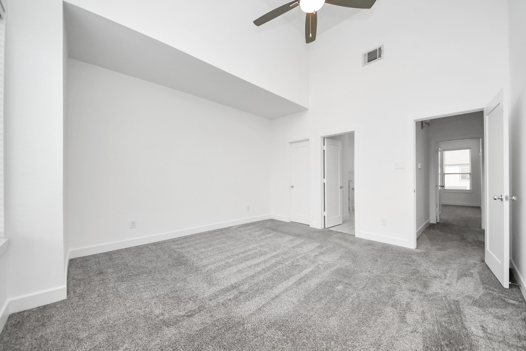 18527 Centro Row Conroe, TX 77385 - Photo 25 of 44 The primary suite is a masterclass in volume, featuring soaring vaulted ceilings and a wide niche ideal for a grand bed or cozy nook.