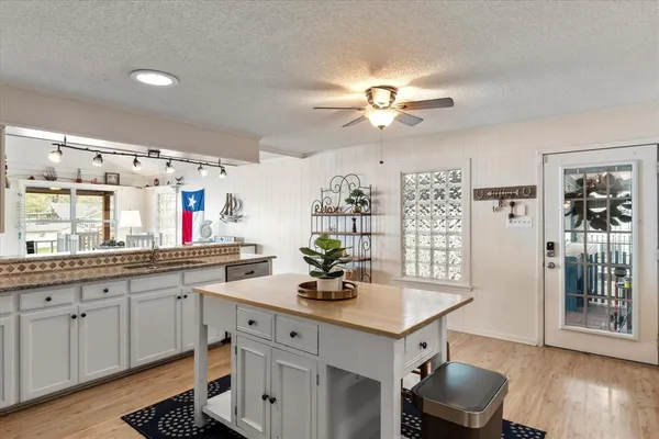 a kitchen with a counter space cabinets and wooden floor