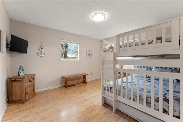 a bedroom with furniture and a flat screen tv