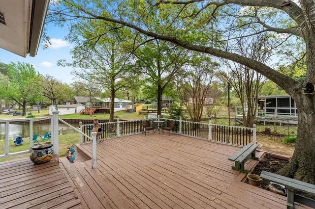 a view of a deck with wooden floor and outdoor seating