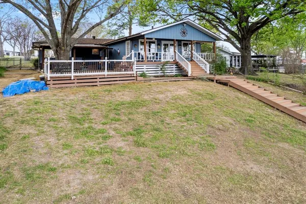 a front view of a house with a yard table and chairs
