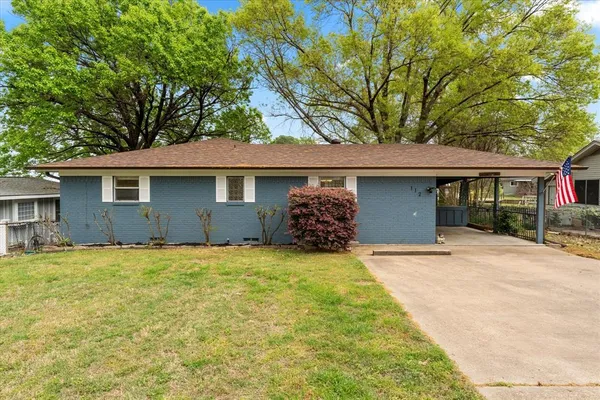 a front view of a house with yard and garage