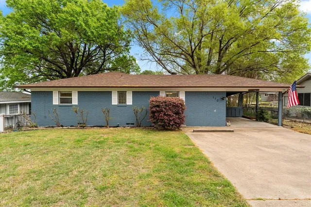 a front view of a house with yard and garage