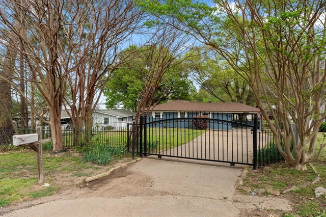 a view of a house with a wooden fence