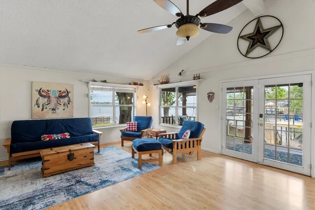 a living room with furniture a flat screen tv and a window