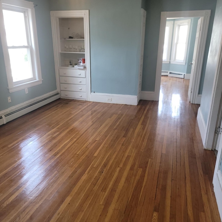 44-46 Butler Street Lawrence, MA 01841 - Photo 5 of 7 wooden floor in an empty room with a window