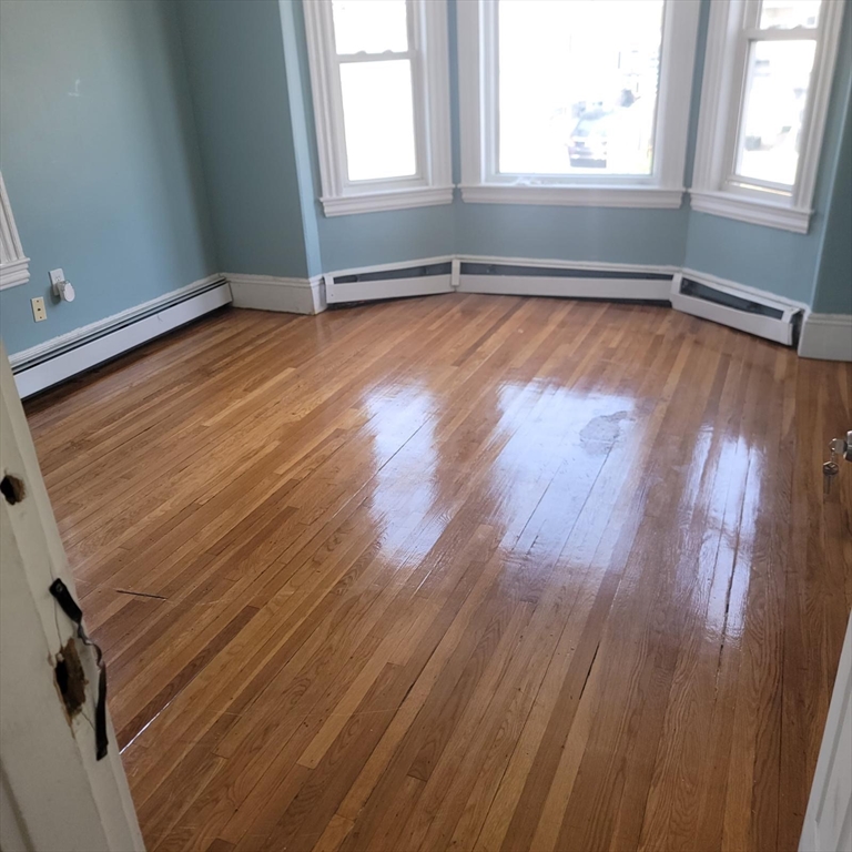 44-46 Butler Street Lawrence, MA 01841 - Photo 6 of 7 an empty room with wooden floor and windows