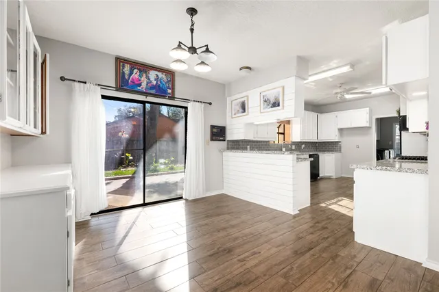 a view of kitchen with cabinets and wooden floor