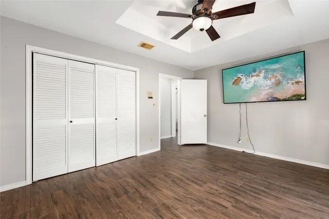 a view of an empty room with wooden floor