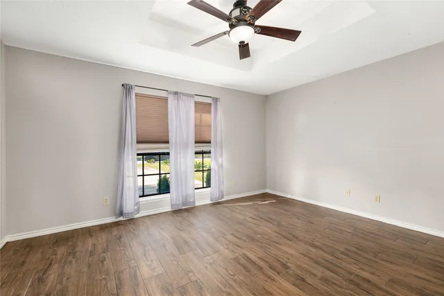 wooden floor in an empty room with a window