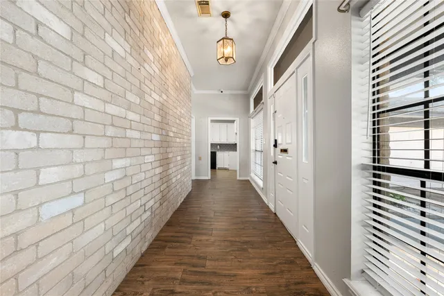 a view of a hallway with wooden floor and staircase