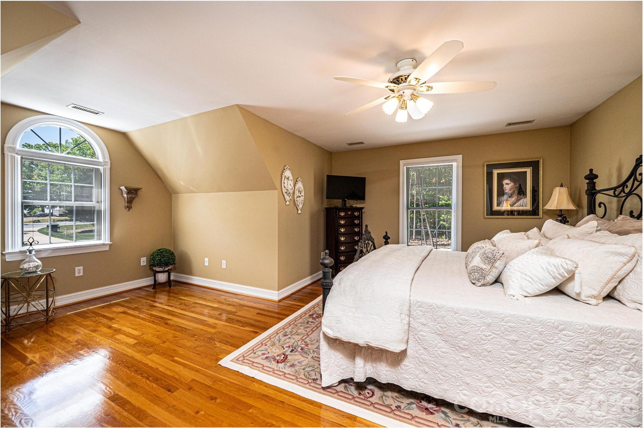 3788 Grace Chapel Road Granite Falls, NC 28630 - Photo 13 of 48 a bedroom with a large bed and a chandelier