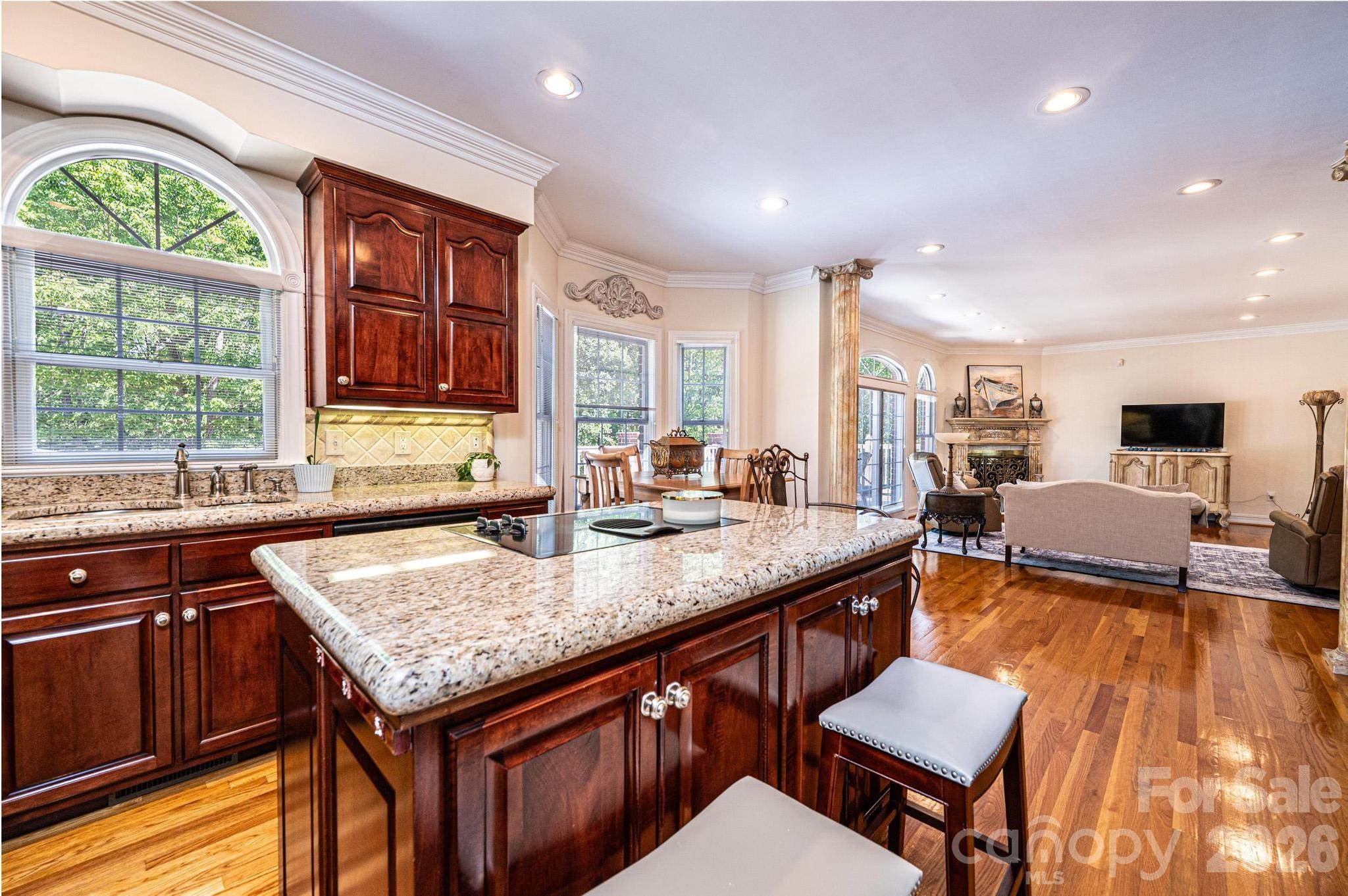 3788 Grace Chapel Road Granite Falls, NC 28630 - Photo 3 of 48 a kitchen with granite countertop a stove a sink a dining table and chairs