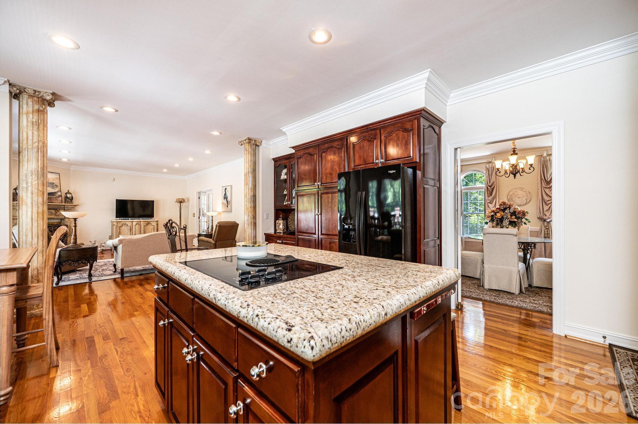 3788 Grace Chapel Road Granite Falls, NC 28630 - Photo 4 of 48 a kitchen island with granite countertop a table and chairs in it
