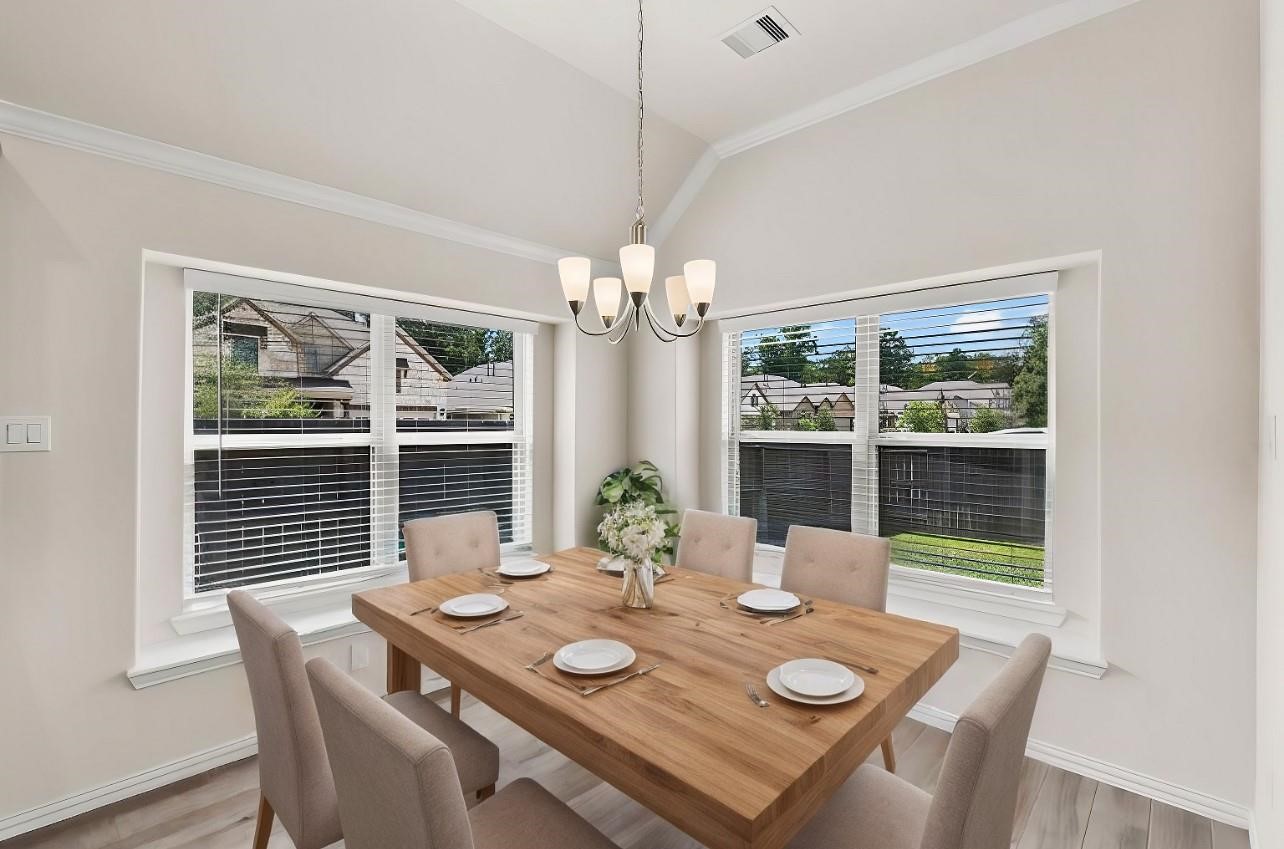 4420 Mimic Drive Spring, TX 77386 - Photo 11 of 40 a view of a dining room with furniture wooden floor and chandelier