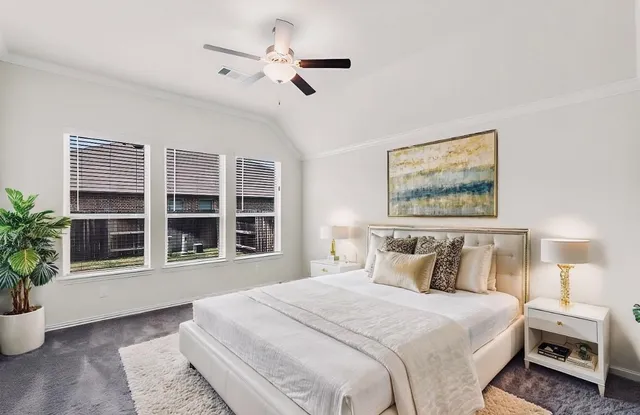 a bedroom with a large bed and a window