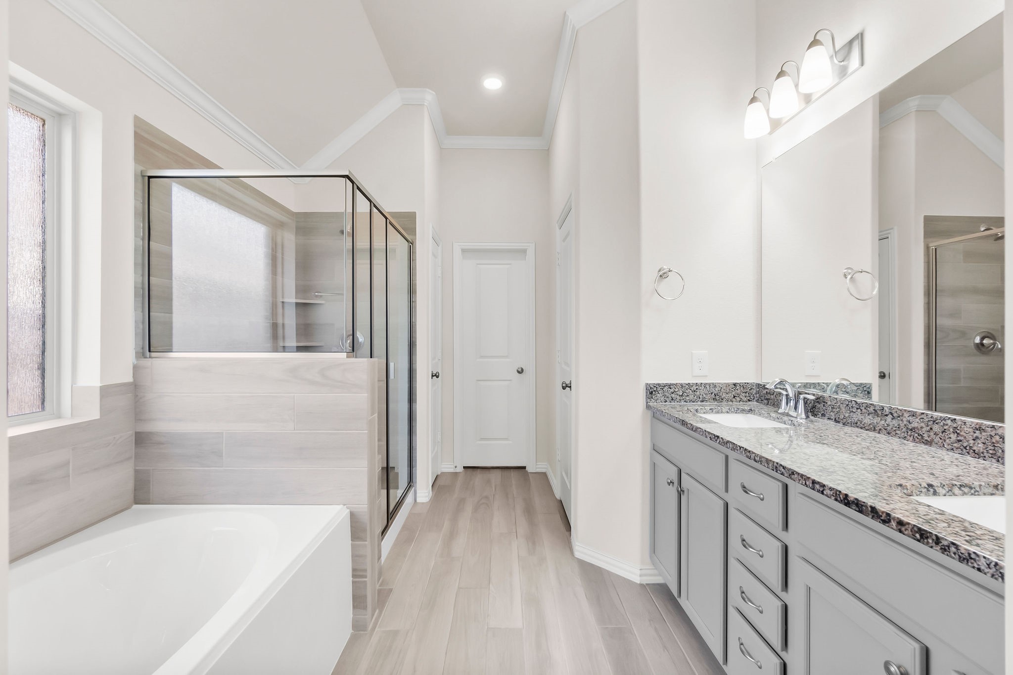 4420 Mimic Drive Spring, TX 77386 - Photo 13 of 40 a bathroom with a granite countertop sink a mirror a bathtub and shower
