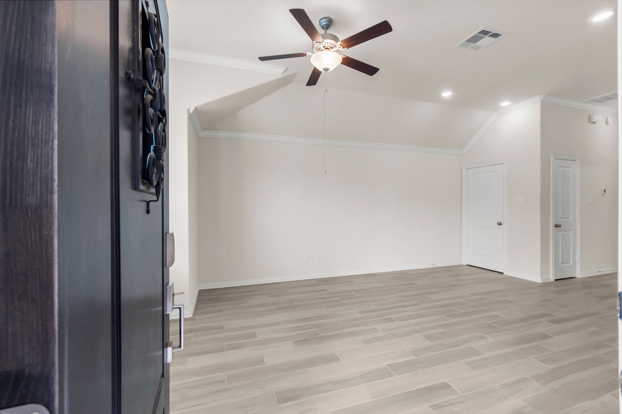 4420 Mimic Drive Spring, TX 77386 - Photo 24 of 40 an empty room with wooden floor and a ceiling fan window
