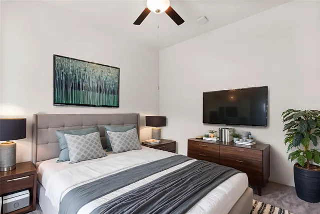 a bedroom with a bed and a flat screen tv