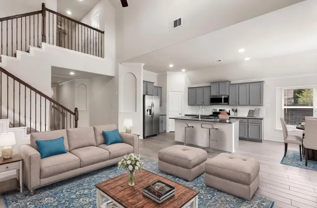 a living room with furniture kitchen view and a window