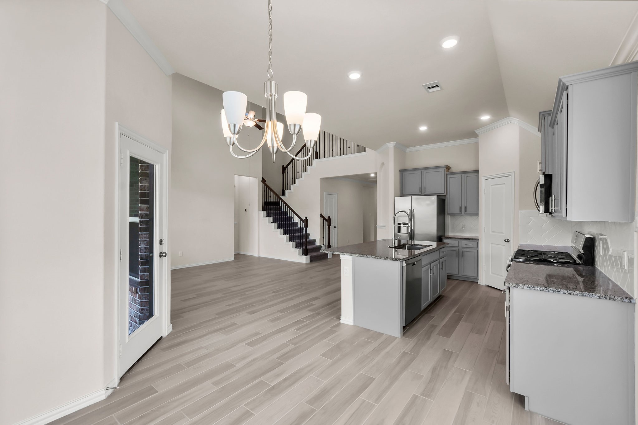 4420 Mimic Drive Spring, TX 77386 - Photo 10 of 40 a kitchen with stainless steel appliances granite countertop a refrigerator a stove oven and white cabinets with wooden floor