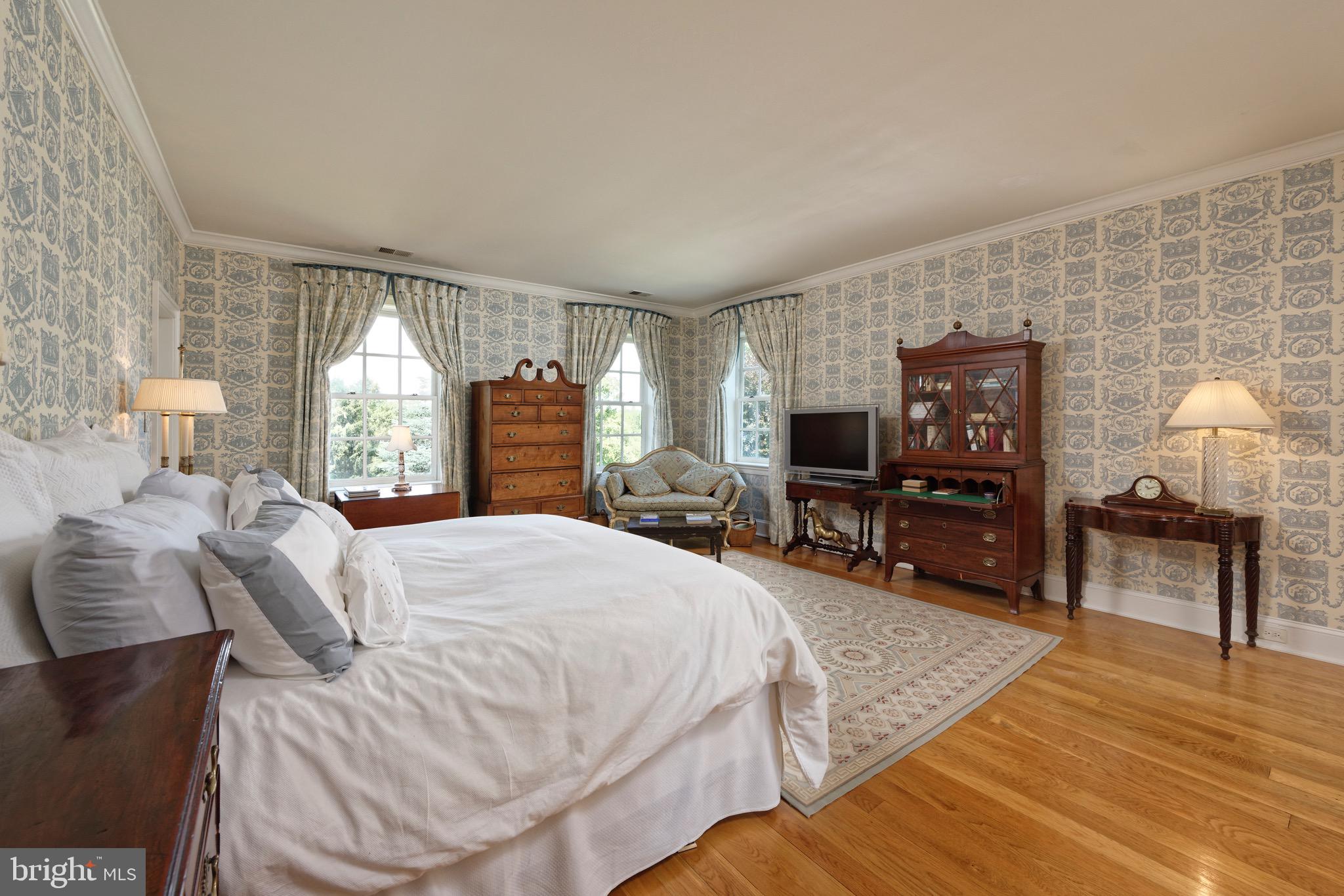 574 Clay Hill Road Boyce, VA 22620 - Photo 22 of 44 a spacious bedroom with a bed a mirror and a flat tv screen on dresser