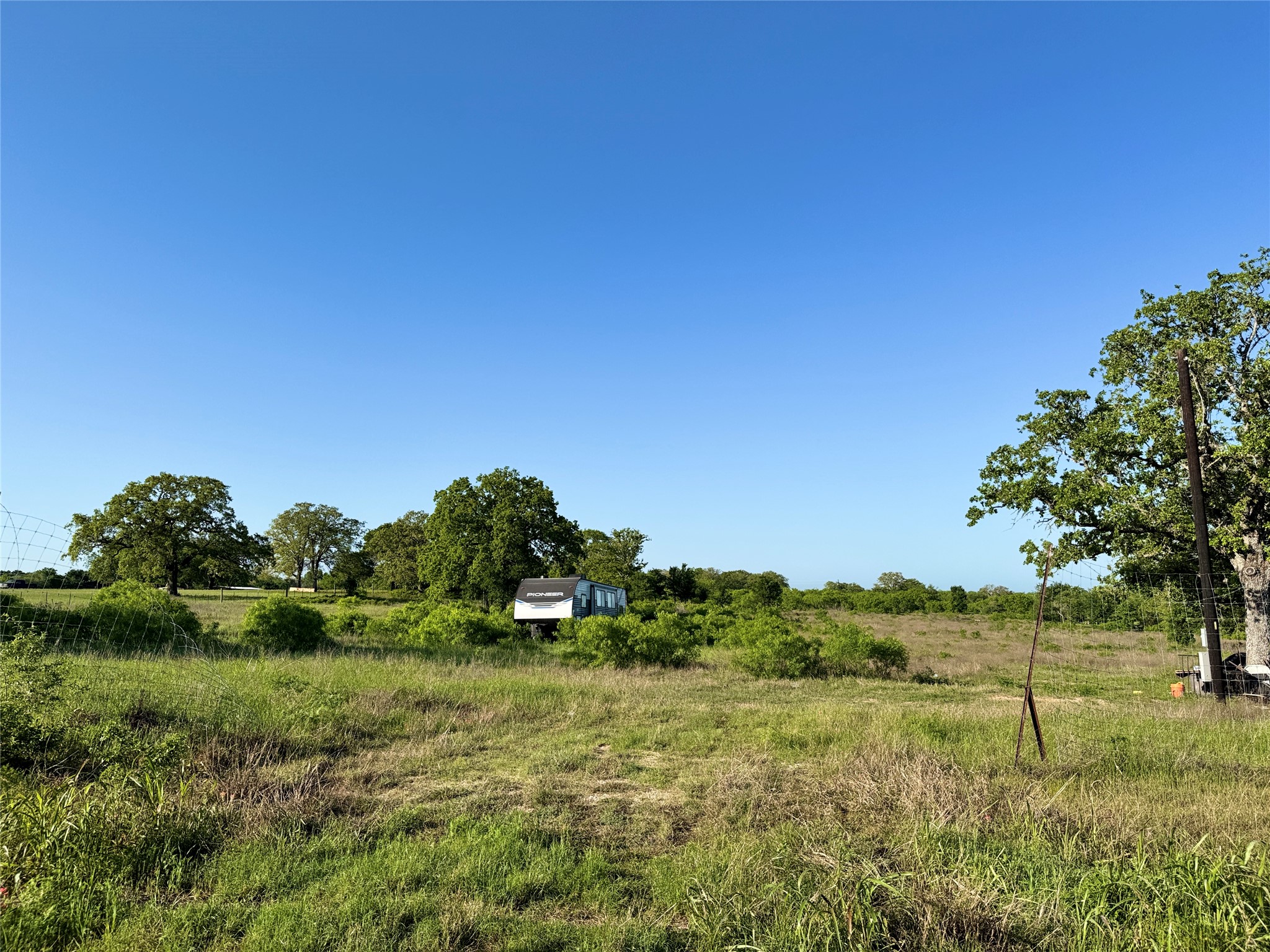 6641 Taylorsville Road Dale, TX 78616 - Photo 21 of 24 a view of a green field with lots of trees