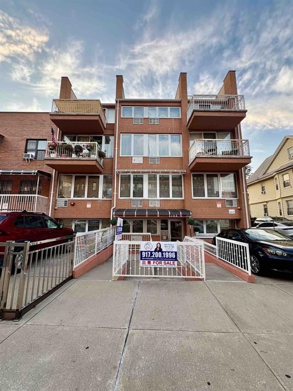an outdoor space with balcony and lounge chairs