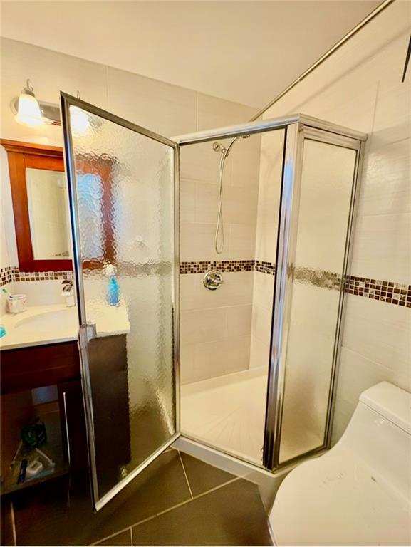 78 Bay 22nd Street, Unit 4 Brooklyn, NY 11214 - Photo 7 of 9 a bathroom with a shower and a mirror