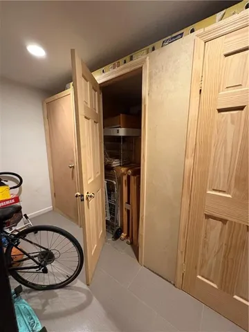 a view of a storage and utility room with two washing machine