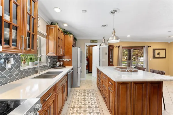 a kitchen with a sink stove and cabinets