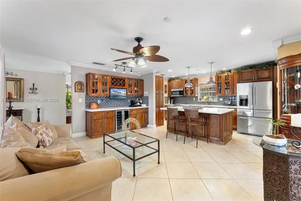 a living room with stainless steel appliances kitchen island granite countertop furniture and a kitchen view