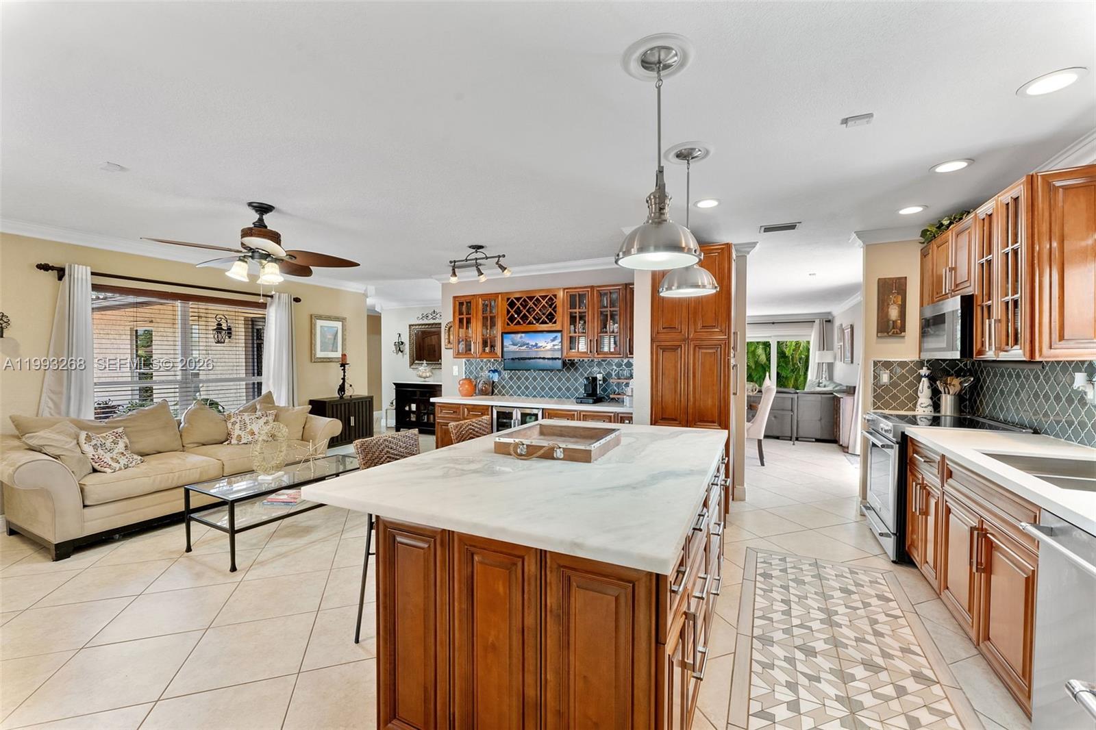 11798 Southwest 32nd Street Miami, FL 33165 - Photo 17 of 31 a kitchen with stainless steel appliances granite countertop a sink stove and refrigerator