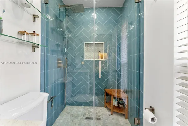 a bathroom with a shower and a toilet